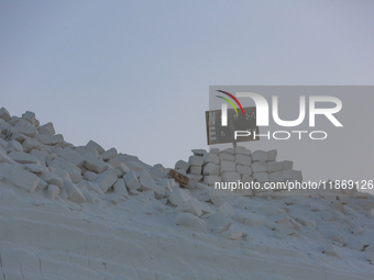 Labourers work at the ''White Mountain'' limestone extraction quarry site near Minya, Egypt, on December 14, 2024. Covered in fine white dus...