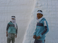 Labourers work at the ''White Mountain'' limestone extraction quarry site near Minya, Egypt, on December 14, 2024. Covered in fine white dus...