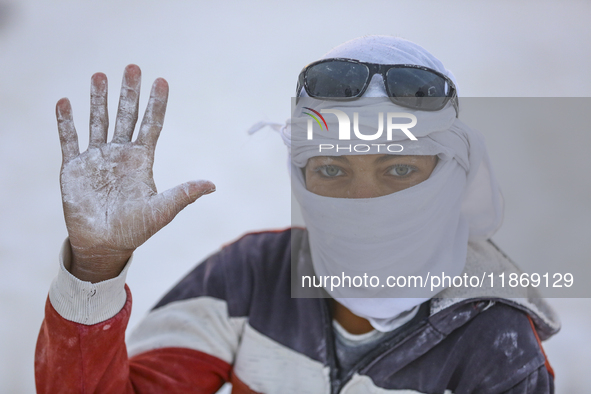 Labourers work at the ''White Mountain'' limestone extraction quarry site near Minya, Egypt, on December 14, 2024. Covered in fine white dus...