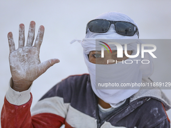 Labourers work at the ''White Mountain'' limestone extraction quarry site near Minya, Egypt, on December 14, 2024. Covered in fine white dus...