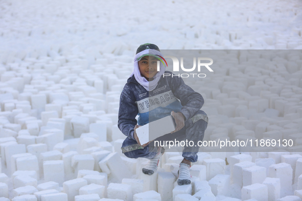 Labourers work at the ''White Mountain'' limestone extraction quarry site near Minya, Egypt, on December 14, 2024. Covered in fine white dus...