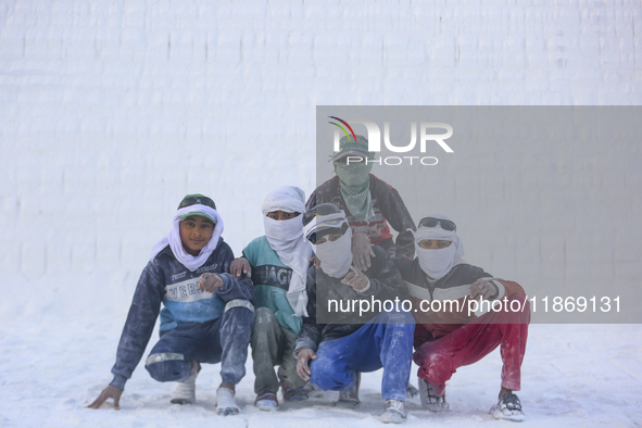 Labourers work at the ''White Mountain'' limestone extraction quarry site near Minya, Egypt, on December 14, 2024. Covered in fine white dus...