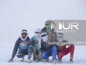 Labourers work at the ''White Mountain'' limestone extraction quarry site near Minya, Egypt, on December 14, 2024. Covered in fine white dus...