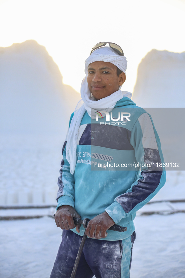 Labourers work at the ''White Mountain'' limestone extraction quarry site near Minya, Egypt, on December 14, 2024. Covered in fine white dus...