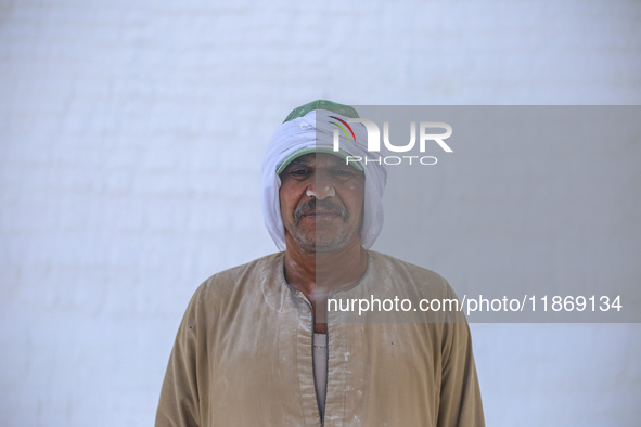 Labourers work at the ''White Mountain'' limestone extraction quarry site near Minya, Egypt, on December 14, 2024. Covered in fine white dus...