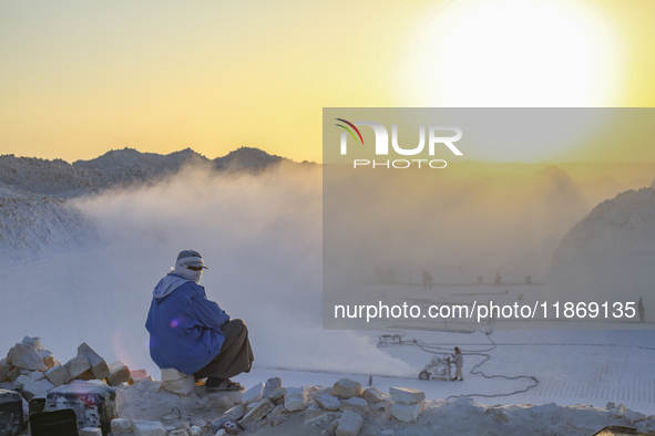 Labourers work at the ''White Mountain'' limestone extraction quarry site near Minya, Egypt, on December 14, 2024. Covered in fine white dus...