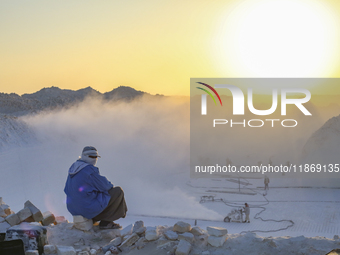 Labourers work at the ''White Mountain'' limestone extraction quarry site near Minya, Egypt, on December 14, 2024. Covered in fine white dus...