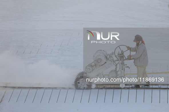 Labourers work at the ''White Mountain'' limestone extraction quarry site near Minya, Egypt, on December 14, 2024. Covered in fine white dus...