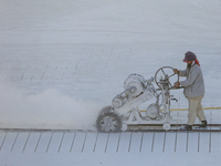 Labourers work at the ''White Mountain'' limestone extraction quarry site near Minya, Egypt, on December 14, 2024. Covered in fine white dus...