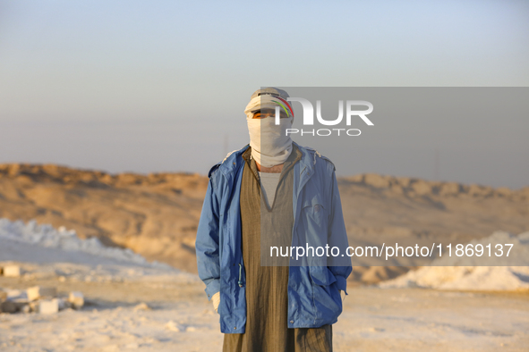 Labourers work at the ''White Mountain'' limestone extraction quarry site near Minya, Egypt, on December 14, 2024. Covered in fine white dus...