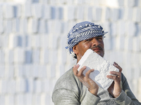 Labourers work at the ''White Mountain'' limestone extraction quarry site near Minya, Egypt, on December 14, 2024. Covered in fine white dus...