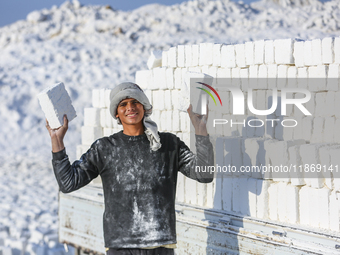 Labourers work at the ''White Mountain'' limestone extraction quarry site near Minya, Egypt, on December 14, 2024. Covered in fine white dus...