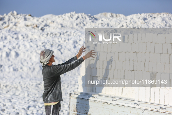 Labourers work at the ''White Mountain'' limestone extraction quarry site near Minya, Egypt, on December 14, 2024. Covered in fine white dus...