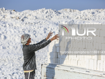 Labourers work at the ''White Mountain'' limestone extraction quarry site near Minya, Egypt, on December 14, 2024. Covered in fine white dus...