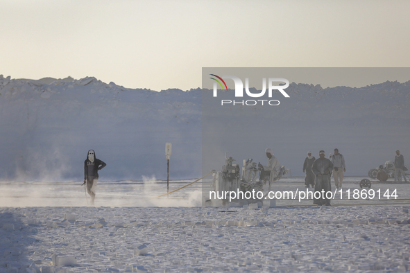 Labourers work at the ''White Mountain'' limestone extraction quarry site near Minya, Egypt, on December 14, 2024. Covered in fine white dus...