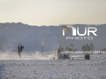 Labourers work at the ''White Mountain'' limestone extraction quarry site near Minya, Egypt, on December 14, 2024. Covered in fine white dus...