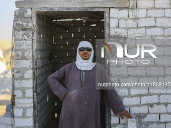 Labourers work at the ''White Mountain'' limestone extraction quarry site near Minya, Egypt, on December 14, 2024. Covered in fine white dus...