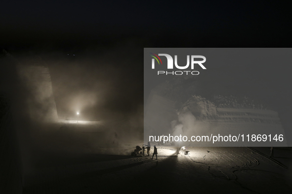 Labourers work at the ''White Mountain'' limestone extraction quarry site near Minya, Egypt, on December 14, 2024. Covered in fine white dus...