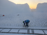 Labourers work at the ''White Mountain'' limestone extraction quarry site near Minya, Egypt, on December 14, 2024. Covered in fine white dus...