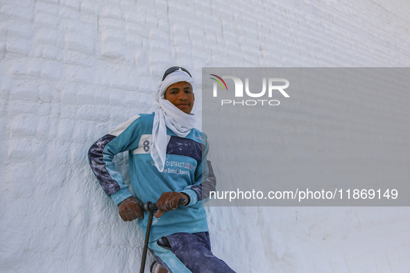 Labourers work at the ''White Mountain'' limestone extraction quarry site near Minya, Egypt, on December 14, 2024. Covered in fine white dus...