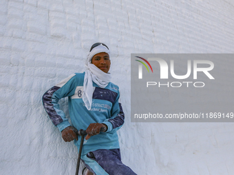 Labourers work at the ''White Mountain'' limestone extraction quarry site near Minya, Egypt, on December 14, 2024. Covered in fine white dus...