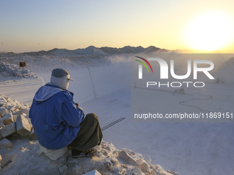 Labourers work at the ''White Mountain'' limestone extraction quarry site near Minya, Egypt, on December 14, 2024. Covered in fine white dus...