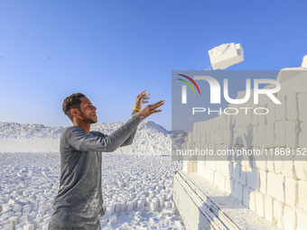 Labourers work at the ''White Mountain'' limestone extraction quarry site near Minya, Egypt, on December 14, 2024. Covered in fine white dus...