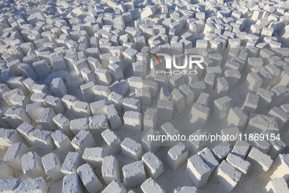 Labourers work at the ''White Mountain'' limestone extraction quarry site near Minya, Egypt, on December 14, 2024. Covered in fine white dus...