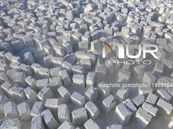 Labourers work at the ''White Mountain'' limestone extraction quarry site near Minya, Egypt, on December 14, 2024. Covered in fine white dus...