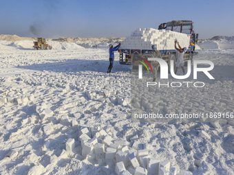 Labourers work at the ''White Mountain'' limestone extraction quarry site near Minya, Egypt, on December 14, 2024. Covered in fine white dus...