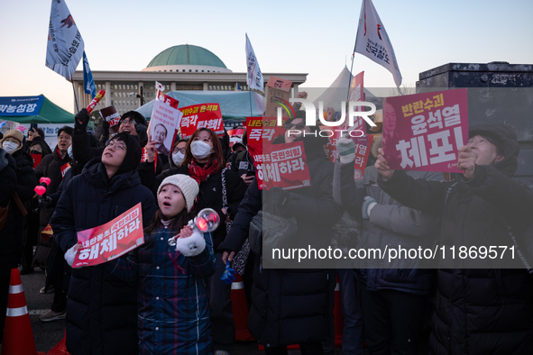 Citizens cheer after the impeachment of President Yoon Suk-yeol is passed in Seoul, South Korea, on December 14, 2024. Approximately 2 milli...