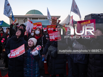 Citizens cheer after the impeachment of President Yoon Suk-yeol is passed in Seoul, South Korea, on December 14, 2024. Approximately 2 milli...