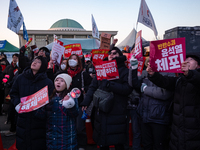 Citizens cheer after the impeachment of President Yoon Suk-yeol is passed in Seoul, South Korea, on December 14, 2024. Approximately 2 milli...