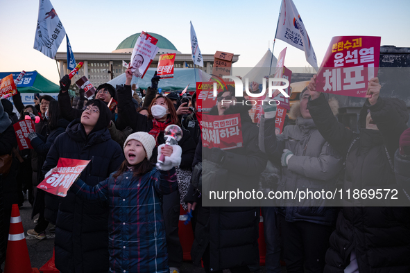 Citizens cheer after the impeachment of President Yoon Suk-yeol is passed in Seoul, South Korea, on December 14, 2024. Approximately 2 milli...