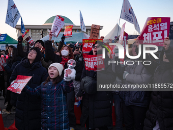 Citizens cheer after the impeachment of President Yoon Suk-yeol is passed in Seoul, South Korea, on December 14, 2024. Approximately 2 milli...