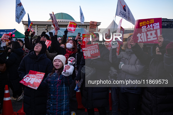 Citizens cheer after the impeachment of President Yoon Suk-yeol is passed in Seoul, South Korea, on December 14, 2024. Approximately 2 milli...