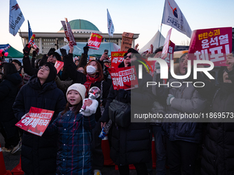 Citizens cheer after the impeachment of President Yoon Suk-yeol is passed in Seoul, South Korea, on December 14, 2024. Approximately 2 milli...