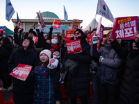 Citizens cheer after the impeachment of President Yoon Suk-yeol is passed in Seoul, South Korea, on December 14, 2024. Approximately 2 milli...