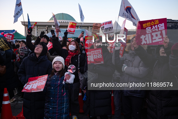 Citizens cheer after the impeachment of President Yoon Suk-yeol is passed in Seoul, South Korea, on December 14, 2024. Approximately 2 milli...