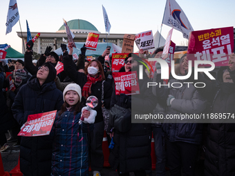 Citizens cheer after the impeachment of President Yoon Suk-yeol is passed in Seoul, South Korea, on December 14, 2024. Approximately 2 milli...