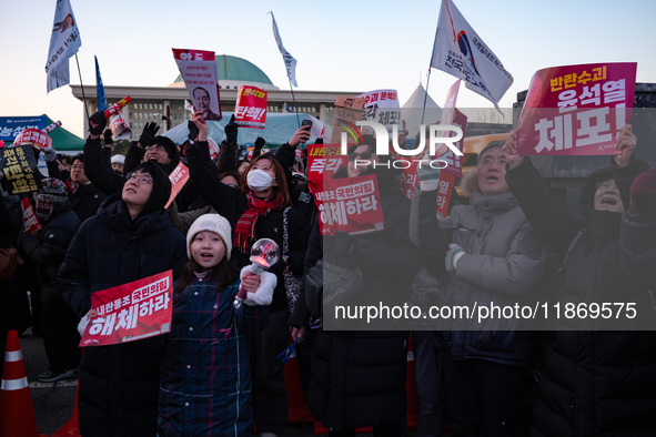 Citizens cheer after the impeachment of President Yoon Suk-yeol is passed in Seoul, South Korea, on December 14, 2024. Approximately 2 milli...