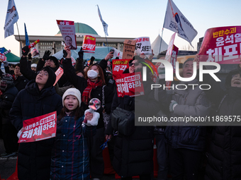 Citizens cheer after the impeachment of President Yoon Suk-yeol is passed in Seoul, South Korea, on December 14, 2024. Approximately 2 milli...