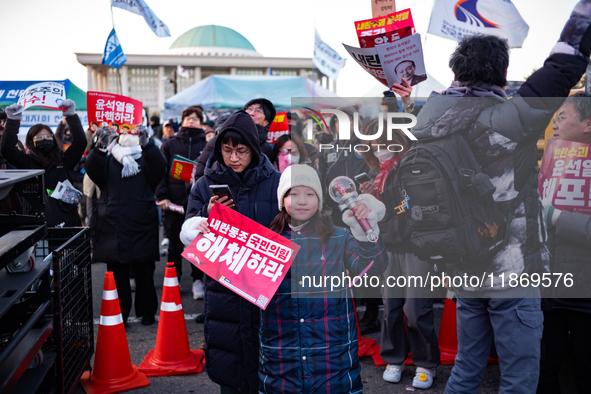 Citizens cheer after the impeachment of President Yoon Suk-yeol is passed in Seoul, South Korea, on December 14, 2024. Approximately 2 milli...