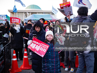 Citizens cheer after the impeachment of President Yoon Suk-yeol is passed in Seoul, South Korea, on December 14, 2024. Approximately 2 milli...