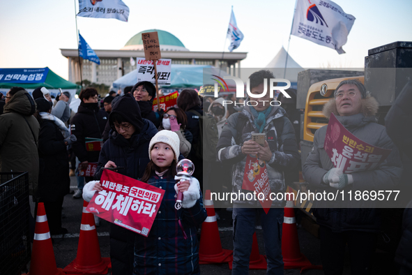 Citizens cheer after the impeachment of President Yoon Suk-yeol is passed in Seoul, South Korea, on December 14, 2024. Approximately 2 milli...