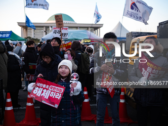 Citizens cheer after the impeachment of President Yoon Suk-yeol is passed in Seoul, South Korea, on December 14, 2024. Approximately 2 milli...