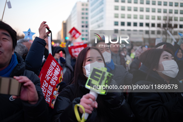 Citizens cheer after the impeachment of President Yoon Suk-yeol is passed in Seoul, South Korea, on December 14, 2024. Approximately 2 milli...