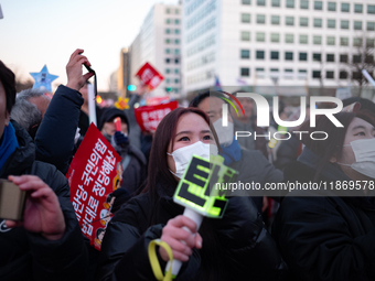 Citizens cheer after the impeachment of President Yoon Suk-yeol is passed in Seoul, South Korea, on December 14, 2024. Approximately 2 milli...