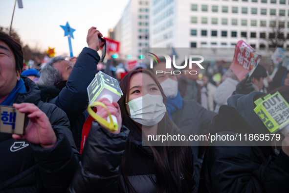 Citizens cheer after the impeachment of President Yoon Suk-yeol is passed in Seoul, South Korea, on December 14, 2024. Approximately 2 milli...