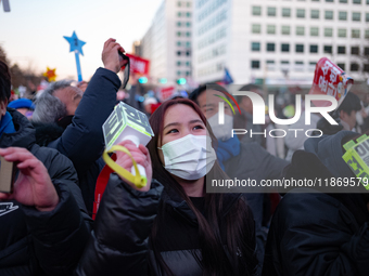 Citizens cheer after the impeachment of President Yoon Suk-yeol is passed in Seoul, South Korea, on December 14, 2024. Approximately 2 milli...